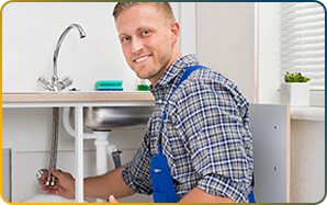 Professional plumbing tools neatly arranged including pipe wrench, copper fittings, and work gloves